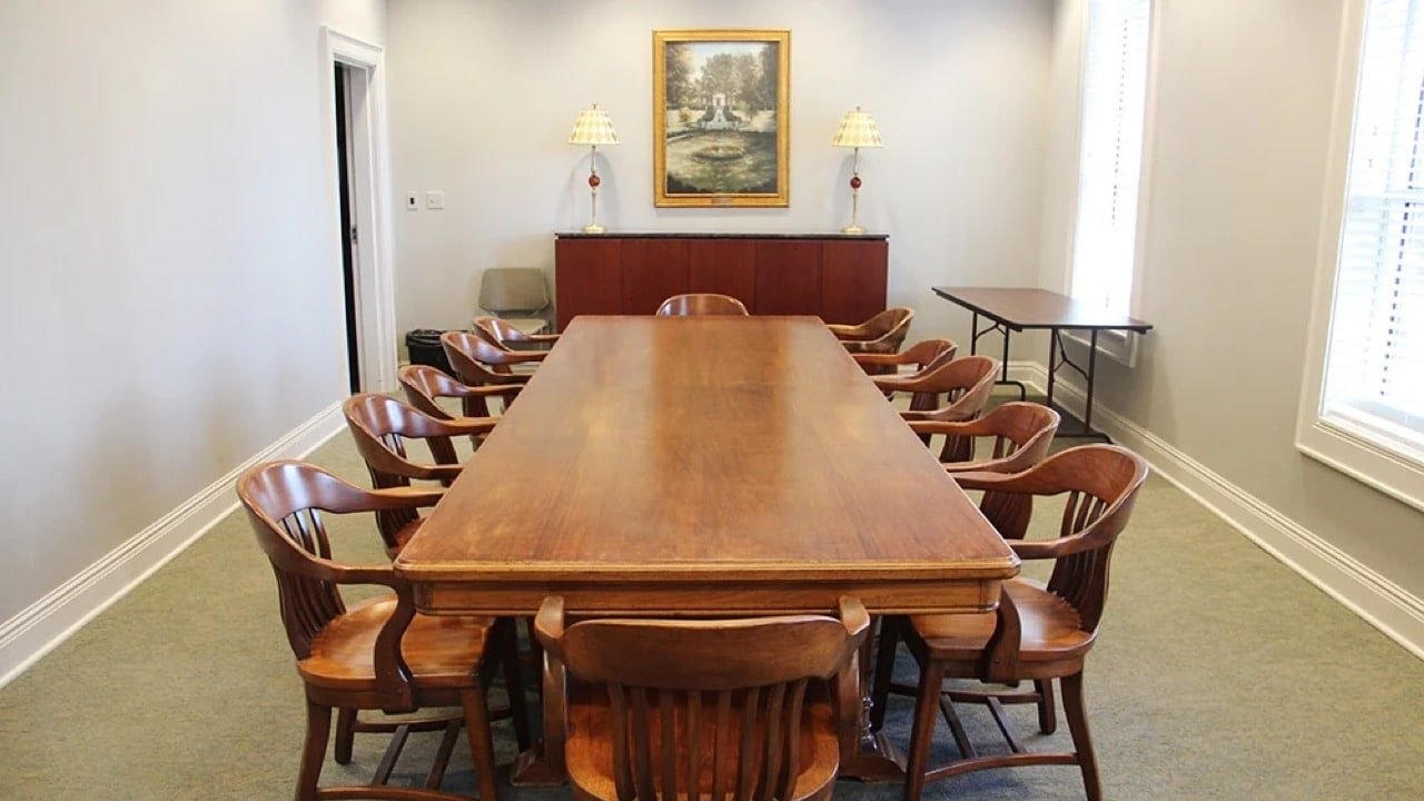 FLPL's board room, which includes a large wooden table surrounded by chairs.