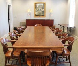 FLPL's board room, which includes a large wooden table surrounded by chairs.