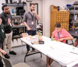 Library staff helping teens with a hands-on activity in the Collaboratory at FLPL